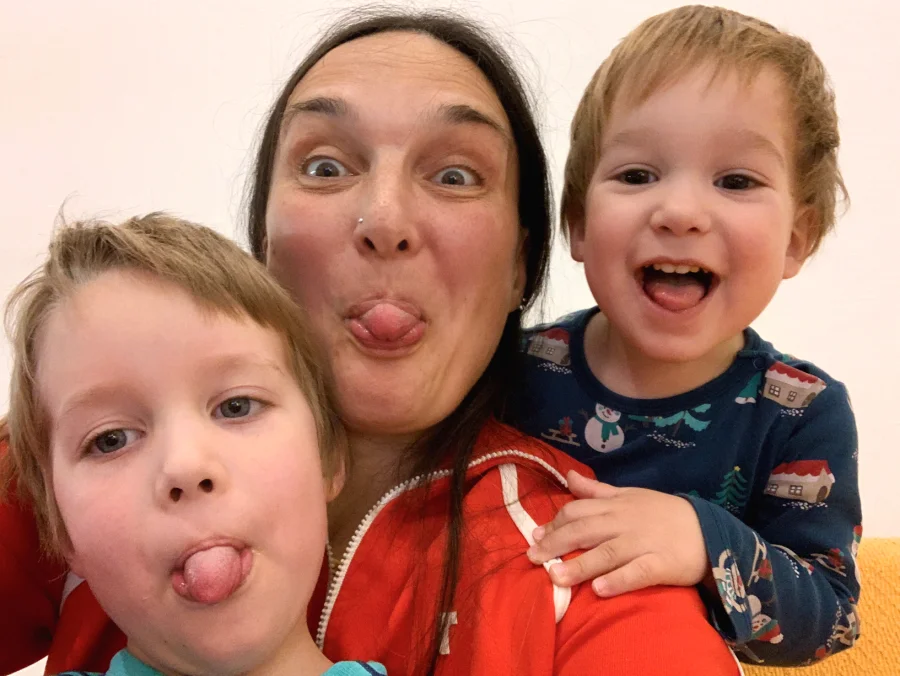 A parent and two children making funny faces together