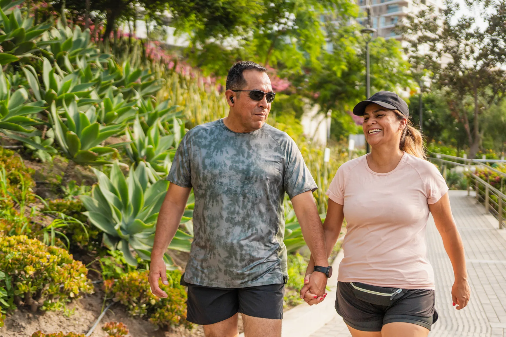 A Latino couple walking together and holding hands