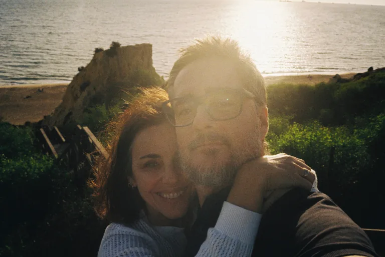 A couple taking a selfie together at the beach