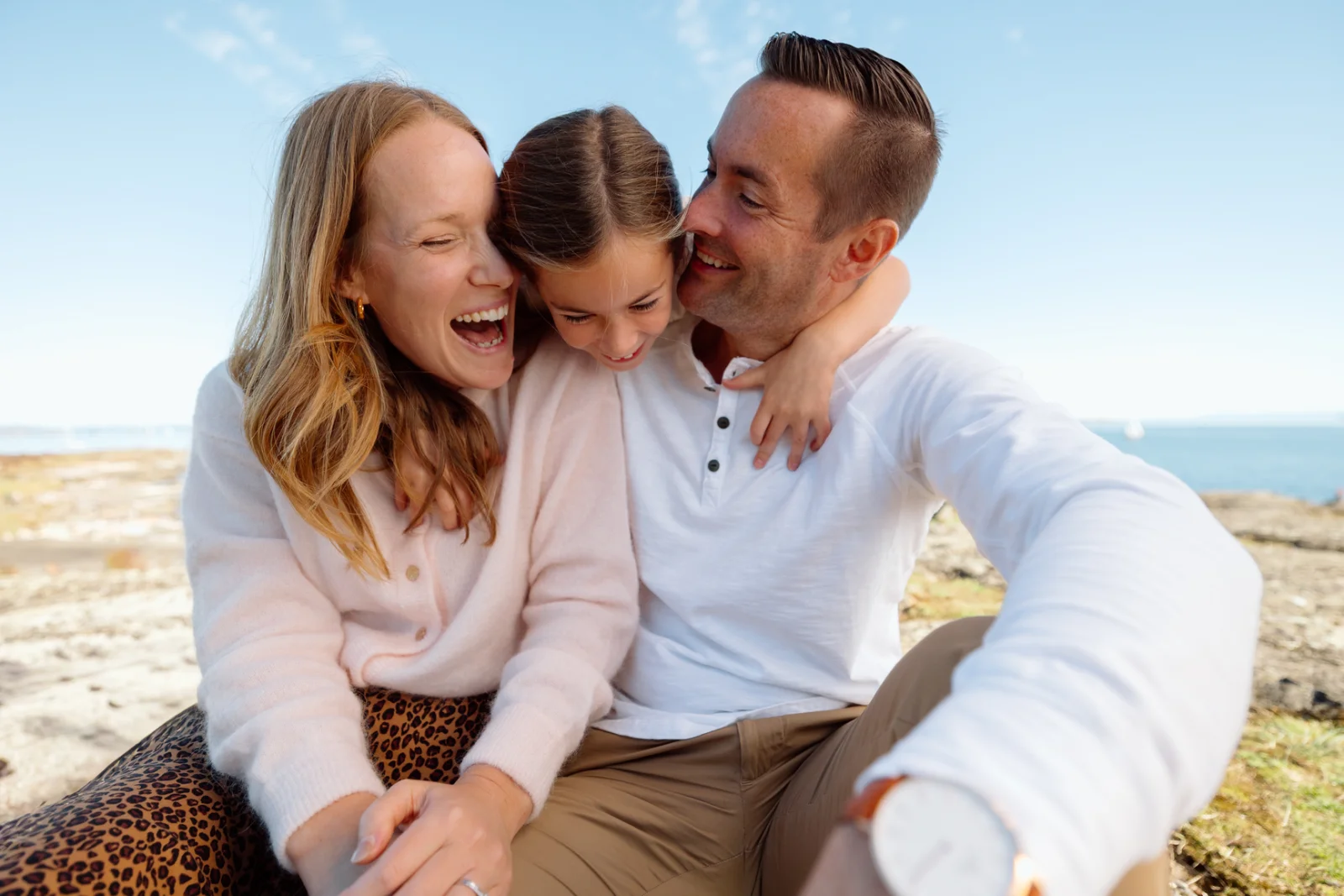 A family sharing a candid moment together at the beach