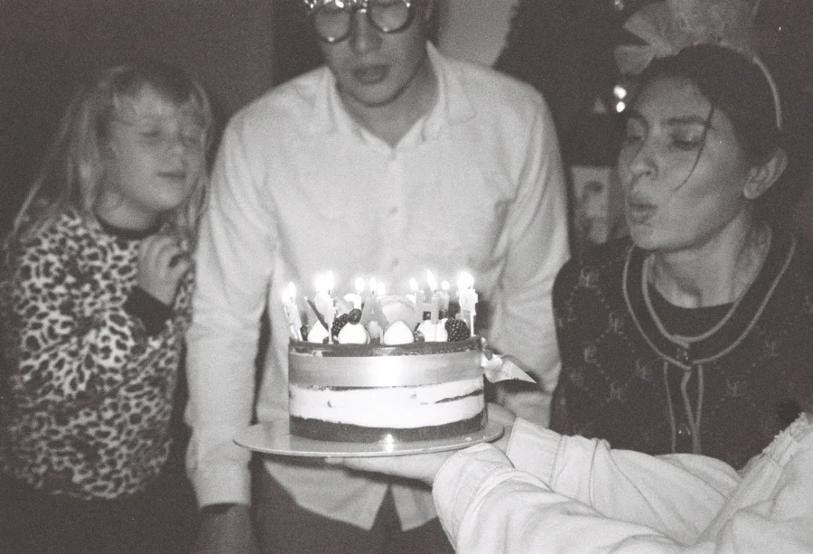 A family celebrating a birthday with cake and candles